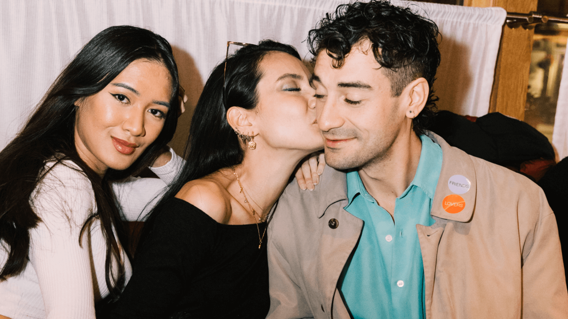 Three people sitting next to each other at a Feeld social